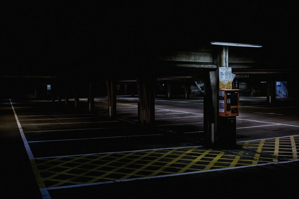 An invented 24-hour motorway service station on a fictional UK A-road, chosen because unstaffed all-night services are a real, familiar liminal space every driver has passed through without questioning who keeps them running.», category=