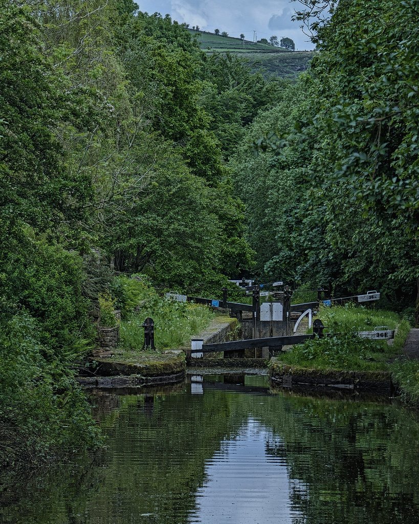 A fictional lock on the English canal network, chosen because lock keeping still runs on paper logs and long solitary night shifts.