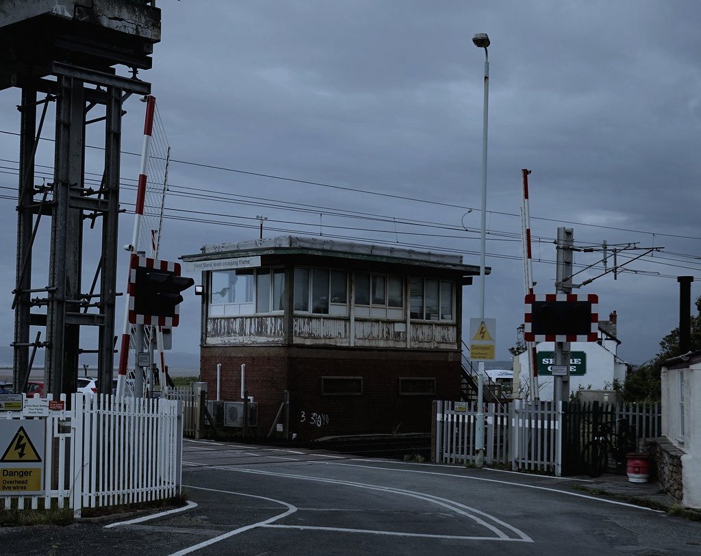 Set at a fictional manual level crossing in rural England, a place where a family job like gatekeeping still shapes daily routine and superstition alike.